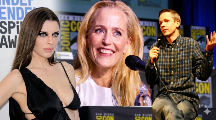 Panel at Comic-Con featuring three speakers: a woman in a black dress on the left, a smiling blonde woman center, and a man in a plaid shirt speaking into a microphone on the right, with Comic-Con banners in the background.
