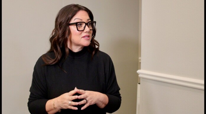 Labor Secretary Chavez-Deremer Exits Amid Probe, Third Woman To Leave Trump Cabinet In Weeks Woman with dark hair and black glasses in a black sweater, speaking with hands clasped in front of her.