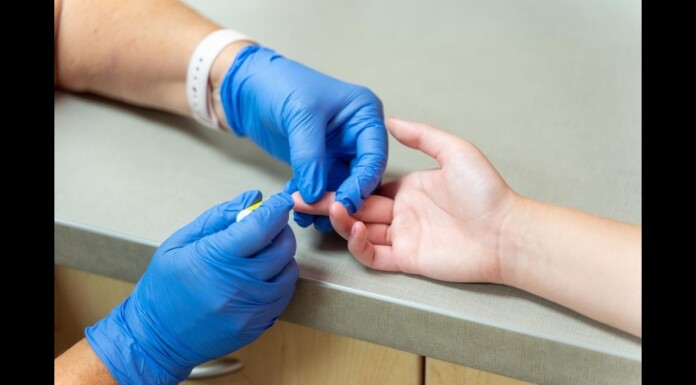 LGBTQ+ Adults Less Likely to Get HIV Tests in States With Refusal Laws Healthcare worker in blue gloves pricking a patient's finger for a blood test or sample collection at a clinical desk area