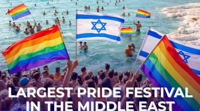 The Middle East’s Largest LGBTQ Festival is Here Crowded beach Pride festival with rainbow and Israeli flags; banner reads 'Largest Pride Festival in the Middle East'.