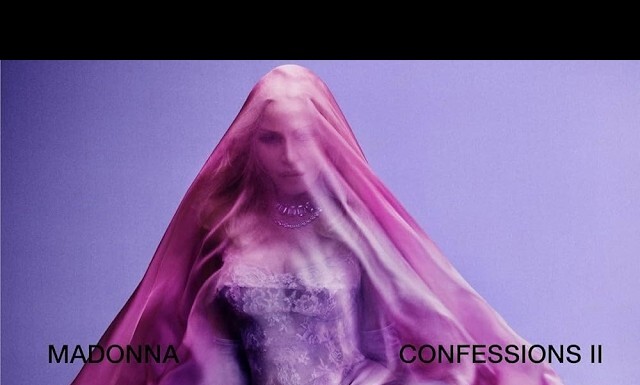 Madonna Announces ‘Confessions II’ Album For July 3 Release Woman in a pink veil over a corseted dress against a lavender backdrop; album title reads 'Madonna Confessions II' (implied without naming).