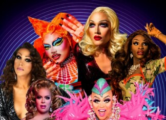 Group of drag queens posing in vibrant outfits against a blue circular-patterned backdrop.