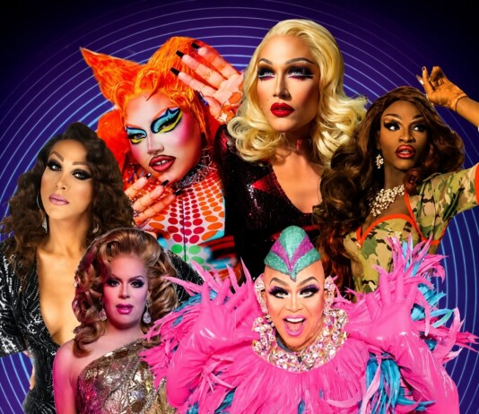 Group of drag queens posing in vibrant outfits against a blue circular-patterned backdrop.