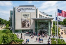 Women’s History Museum Bill Fails After GOP Adds Transgender Exclusion Rule Front view of the National Museum of American Women’s History with large banner and American flag outside; people gather at the entrance on a sunny day.