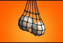 Two white volleyballs in a black mesh bag hanging against an orange gradient background.