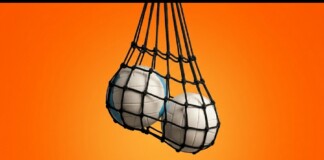 Two white volleyballs in a black mesh bag hanging against an orange gradient background.