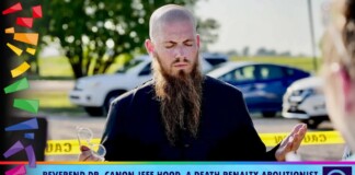 Bearded man in black speaks with eyes closed outdoors; yellow caution tape and parked cars in the background, colorful confetti shapes on the left, banner text at bottom reads about a death-penalty abolitionist ministerial partner.