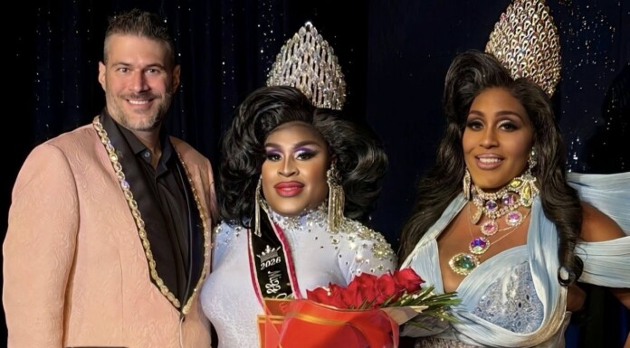 A Crown And A Cause. Mizz Out South Florida Celebrates Drag, Community, And Philanthropy Three drag performers pose on stage; center winner in a silver gown and crown holds a red rose bouquet, flanked by two smiling contestants.