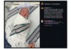 Newborn baby swaddled in a striped hospital blanket with a pink bow headband, lying in a hospital bed. That the image shows a birth announcement in a social post context.