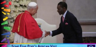Pope in red ceremonial robes shaking hands with an African president during a formal meet, with a news banner beneath reading a controversial headline.