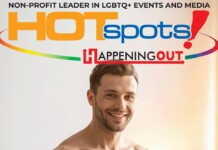 Smiling man in front of a colorful banner that reads HOTspots and Happening Out, promoting LGBTQ+ events and media.