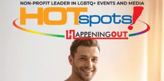 Smiling man in front of a colorful banner that reads HOTspots and Happening Out, promoting LGBTQ+ events and media.