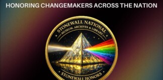 Gold medal with a glass pyramid that emits a rainbow beam, edged text reads 'Stonewall National Museum, Archives & Library' and 'Stonewall Honors' around the circle.