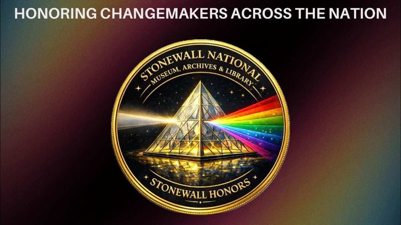 Stonewall Honors To Celebrate LGBTQ+ Leaders With Awards Gala & New Pride Exhibition, May 30 Gold medal with a glass pyramid that emits a rainbow beam, edged text reads 'Stonewall National Museum, Archives & Library' and 'Stonewall Honors' around the circle.