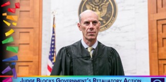 Judge in robe stands in a courtroom; on-screen headline reads: 'Judge Blocks Government’s Retaliatory Action Against Trans Affirming Health Organizations'
