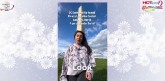 Woman in a patterned sweater stands outdoors on a grassy field with a tall obelisk; overlaid text promotes a rivalry lookalike contest and logos.