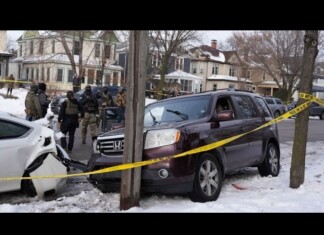 Renée Good Shooting: Widow Demands SUV Return After Feds Decline Probe Winter residential crash scene: a maroon SUV and a white car damaged, police and responders behind yellow caution tape, snow on the ground.