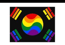 Circular rainbow emblem at center with red, orange, yellow, green, blue, and purple swooshes, surrounded by four corner color bars on a black background — a Pride/LGBTQ symbol.