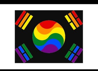 Circular rainbow emblem at center with red, orange, yellow, green, blue, and purple swooshes, surrounded by four corner color bars on a black background — a Pride/LGBTQ symbol.