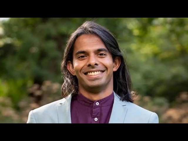 Transgender Lawmakers Win Scottish Parliament Seats in Region Where J.K. Rowling Lives Smiling man with long dark hair in a light blue blazer and maroon shirt, outdoors in greenery