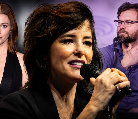 Deep Inside Hollywood: Audrey Hepburn Biopic, ‘Las Malas,’ Parker Posey, Nick Jonas & More Entertainment News Female singer in front holding a microphone, flanked by a red-haired woman in black on the left and a bearded man with glasses on the right at a panel event.