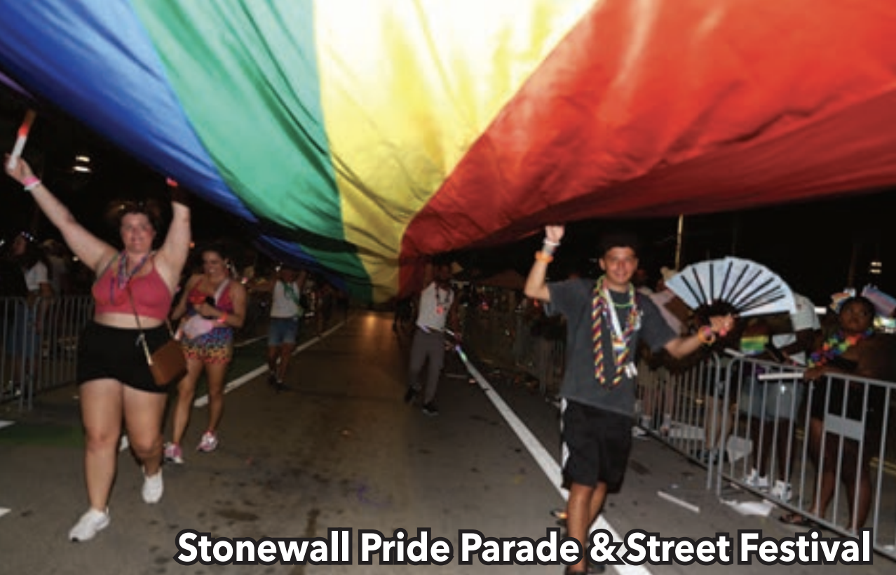 What’s Hot South Florida: June 19 – July 02 | Hotspots Magazine Hotspots Magazine Participants walk under a large rainbow parachute during Stonewall Pride Parade & Street Festival at night framing the street crowd around barriers.