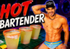 HOT Bartender – Jaime Erben Muscular, shirtless bartender wearing a cap stands beside three salted margaritas on a neon-lit bar.