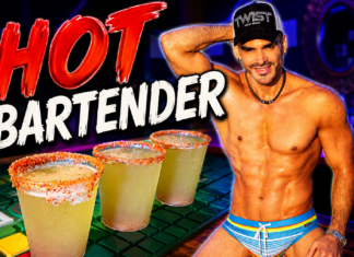 Muscular, shirtless bartender wearing a cap stands beside three salted margaritas on a neon-lit bar.