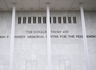 Marble wall with engraved text reading: 'THE DONALD TRUMP AND THE JOHN F. KENNEDY MEMORIAL CENTER FOR THE PERFORMING ARTS'