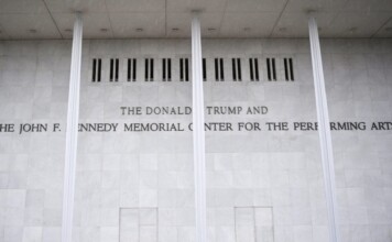 Marble wall with engraved text reading: 'THE DONALD TRUMP AND THE JOHN F. KENNEDY MEMORIAL CENTER FOR THE PERFORMING ARTS'