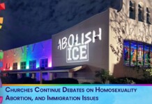 Nighttime church exterior with rainbow lighting and the graffiti 'ABOLISH ICE' on the wall, plus a banner about church debates on sexuality, abortion, and immigration.