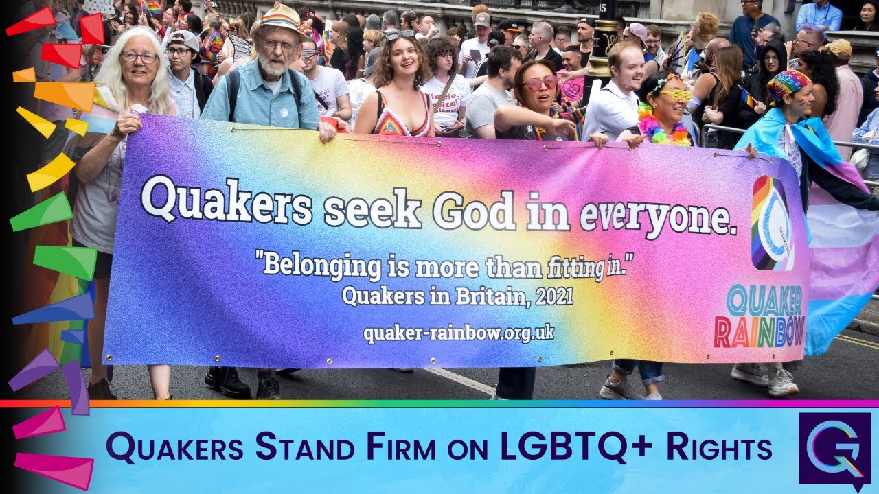 Diverse marchers hold a rainbow banner reading 'Quakers seek God in everyone' at a Pride parade; bottom bar promotes LGBTQ+ rights.