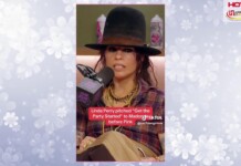 Woman wearing a wide black hat and plaid shirt speaks into a microphone during a radio interview, with a red caption about Linda Perry visible on screen.