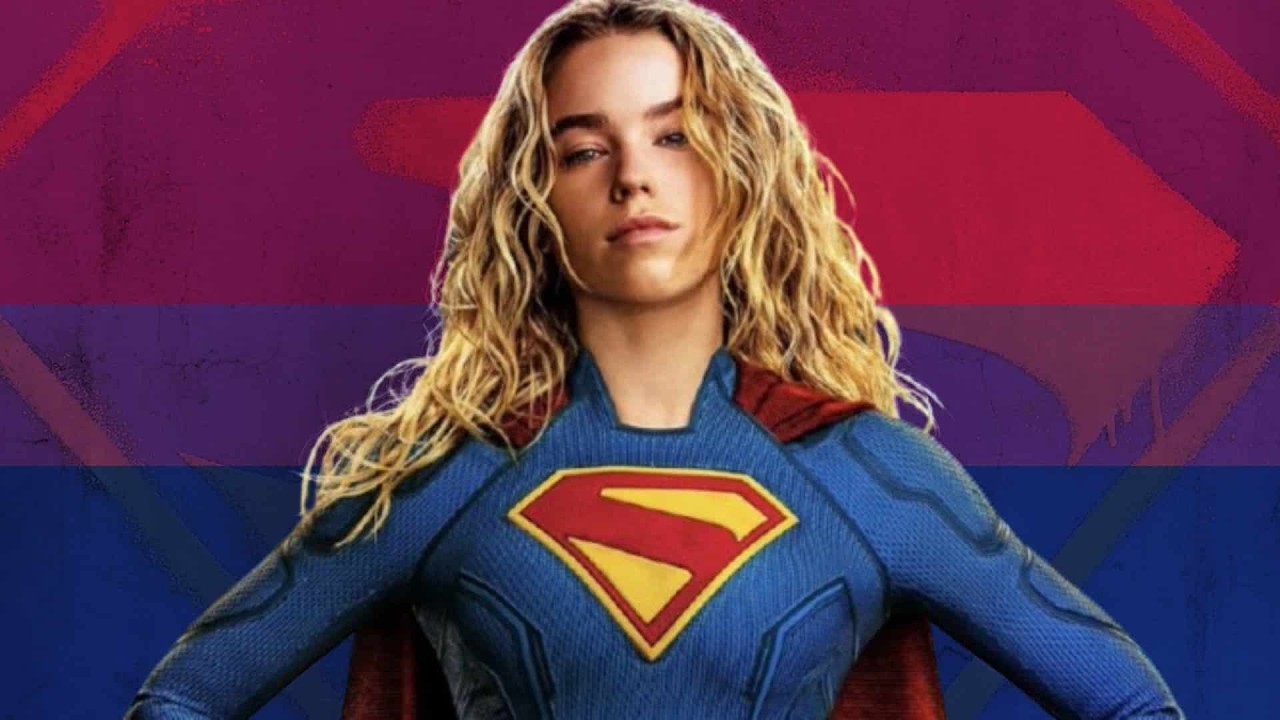 Fox News Host Sparks Backlash Over Comments About Bisexual Women Woman in a blue Superman costume with red cape, hands on hips, against a rainbow-striped background.