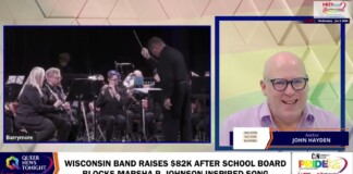 Split-screen news frame: left shows a small orchestra with conductor and players; right shows anchor John Hayden in a bright studio. Bottom headline reads: Wisconsin band raises $82K after school board blocks Marsha P. Johnson-inspired song.