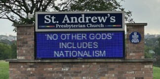 St. Andrew's Presbyterian Church sign with a blue LED marquee displaying: 'NO OTHER GODS INCLUDES NATIONALISM' on a brick base.