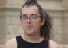 Trans Woman Named Rihanna Kelver Charged Despite Wyoming ‘Stand Your Ground’ Self-Defense Law Person with purple glasses and a septum piercing looks to the side, wearing a black sleeveless top outdoors near a stone building.