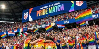 USA soccer players celebrate with arms around each other as fans wave rainbow flags at the World Cup 2026 Pride Match.