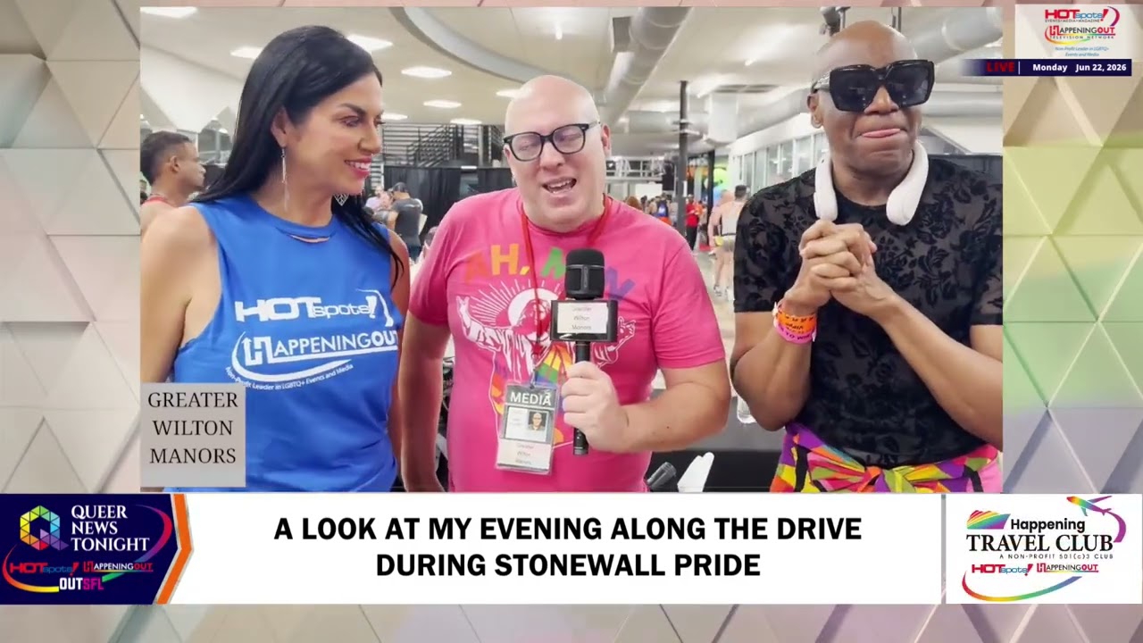 Three TV hosts in a studio during a Pride segment: center man with a microphone and media badge, flanked by a woman in blue and a man in sunglasses; on-screen headline references Stonewall Pride and a lower-third banner.