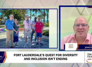 Television news split-screen: outdoor press conference on the left with five people at a podium, and a studio anchor in a pink shirt on the right.