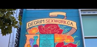Colorful mural on a building advocating for decriminalization of sex work in California, with raised fists and flowers.