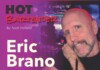 Poster for 'HOT BARTENDER' featuring Eric Brano; by Scott Holland, with a man in a bar posing with a drink in the foreground.