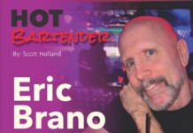 Hot Bartender: Eric Brano Poster for 'HOT BARTENDER' featuring Eric Brano; by Scott Holland, with a man in a bar posing with a drink in the foreground.