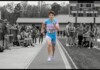 US Supreme Court Upholds State Bans on Transgender Girls Competing in Girls’ Sports Runner in a blue-pink uniform sprinting on a track with bib 102, as spectators watch from the sidelines.