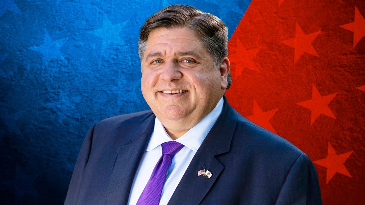 Illinois Expands LGBTQ+ Protections With New Laws on Health Care, Privacy, and Gender IDs Portrait of a smiling man in a dark suit and purple tie, wearing a US flag lapel pin, against a blue and red starry background.