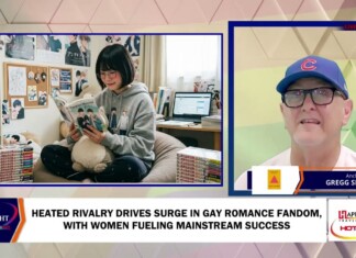 Heated Rivalry Drives Surge In Gay Romance Fandom, With Women Fueling Mainstream Success Young person in a gray hoodie reads a manga on a comfy chair, surrounded by shelves of books and a plush toy in a cozy room.
