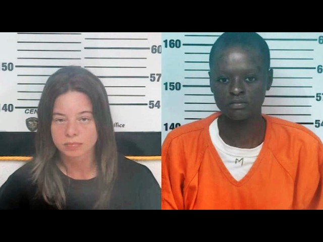 Side-by-side mugshots against a height chart: left, a light-skinned woman with shoulder-length brown hair in a black shirt; right, a dark-skinned man with short hair wearing an orange jumpsuit over a white shirt.