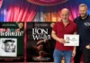 Island City Stage Celebrates 15th Anniversary Season With 2026–27 Line-up Two men pose with colorful stage posters for Island City Stage productions: 'Who Killed Joan Crawford?' and 'The Lion in Winter'.