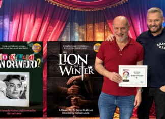 Two men pose with colorful stage posters for Island City Stage productions: 'Who Killed Joan Crawford?' and 'The Lion in Winter'.