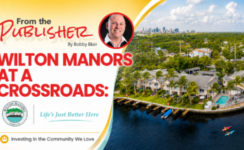Promotional banner: Wilton Manors at a Crossroads with a portrait, city skyline, and waterway image; bold red title and crest logos.
